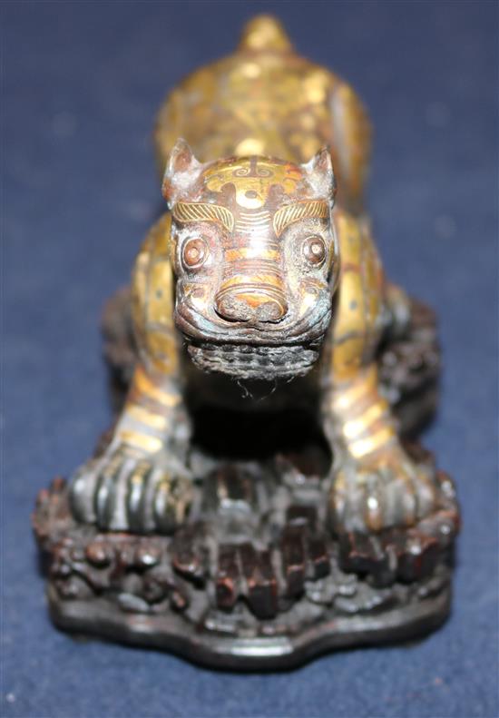 A Chinese parcel gilt bronze figure of a tiger, in Song dynasty style, length 18cm, together with a fitted hardwood box